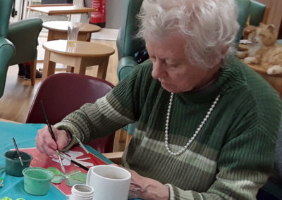 Lady residents concentrating on St Patricks Day crafts