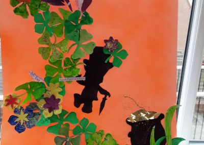 Display made from green paper shamrocks with an orange background