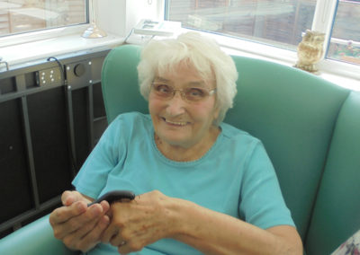 One of the ladies at The Old Downs Residential Care Home holding a centipede from Zoolab