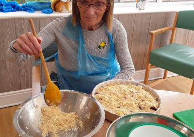 Resident mixing crumble ingredients in a bowl