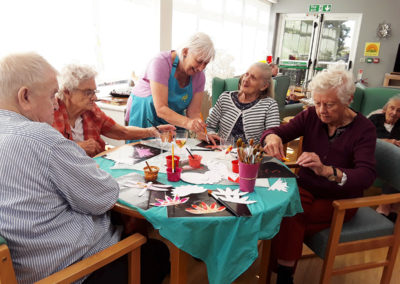 Residents at The Old Downs creating parts of a flamingo collage with Creative Mojo