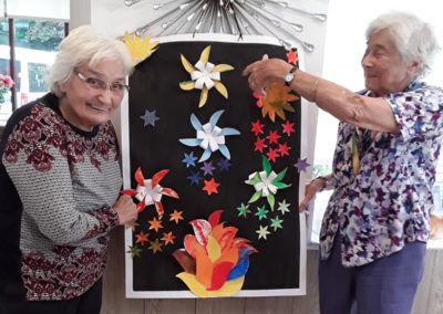 Two ladies from The Old Downs showing off the group's painted firework collage