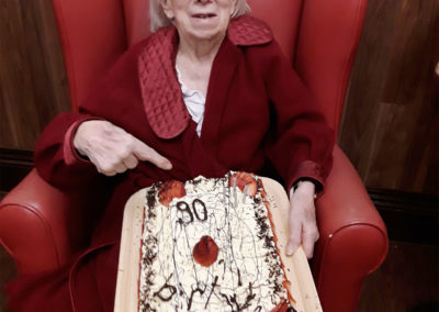 Resident Gwen at The Old Downs receiving a special cake for her birthday