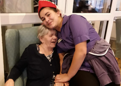 Staff and resident cuddling and laughing together