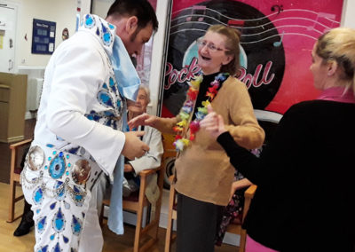 Lady resident dancing with an Elvis tribute singer