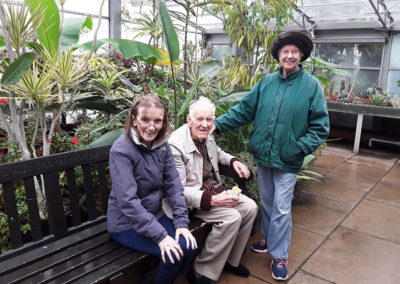 A group of Old Downs residents inside a temperate greenhouse at Hall Place