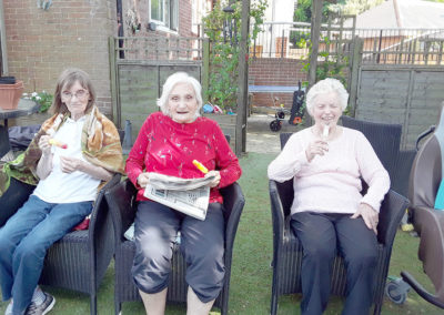 Residents enjoying ice lollies in the garden at The Old Downs