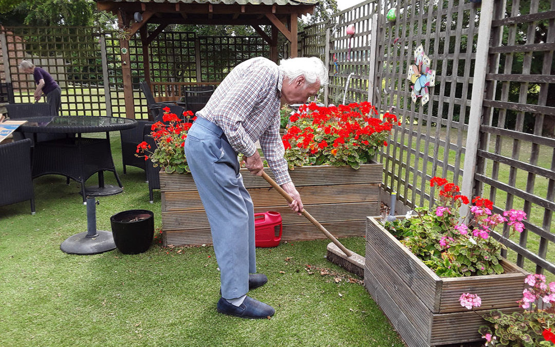 Tidying the garden at The Old Downs Residential Care Home