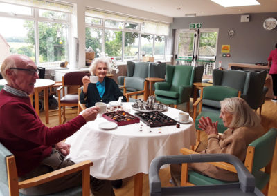 Resident from The Old Downs socialising over chocolates and a cuppa
