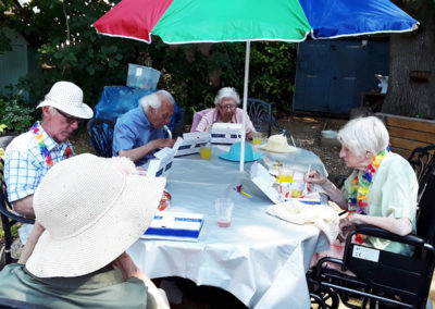 Residents having fish and chips in the garden at The Old Downs Residential Care Home