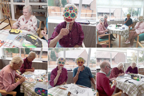 Residents colouring Halloween masks at The Old Downs Residential Care Home