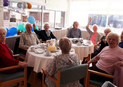 Residents having a birthday tea party