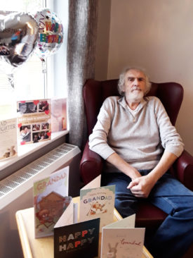 Male resident with his birthday cards at the The Old Downs Residential Care Home