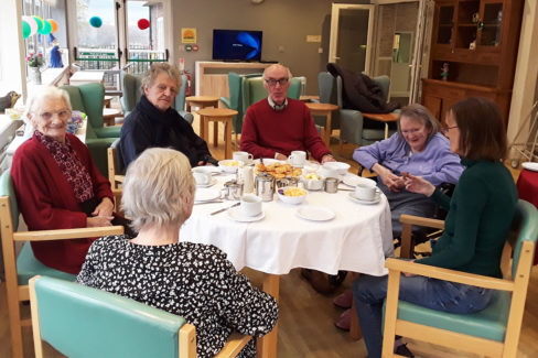 Residents enjoying tea and scones at The Old Downs Residential Care Home