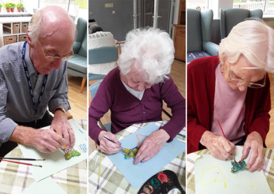 The Old Downs Residential Care Home residents painting butterfly sun catchers