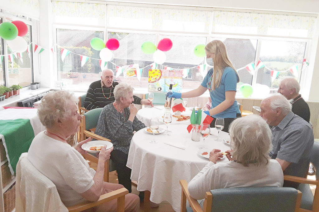 Residents at The Old Downs Residential Care Home enjoying their homemade pizzas on Italian Day