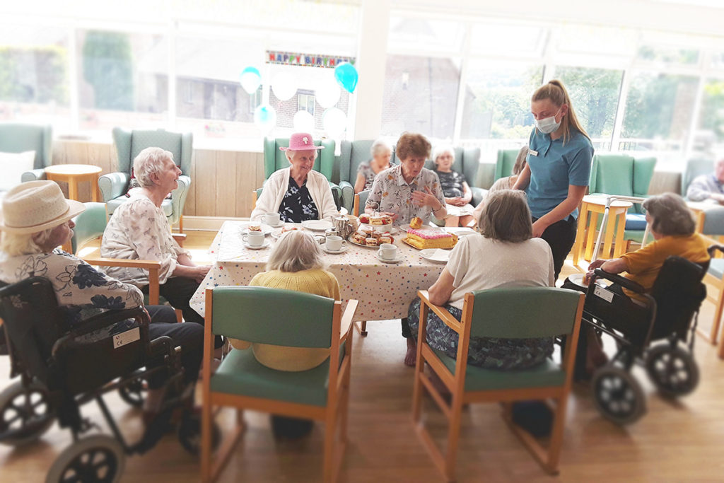 Residents enjoying a birthday tea party at The Old Downs Residential Care Home