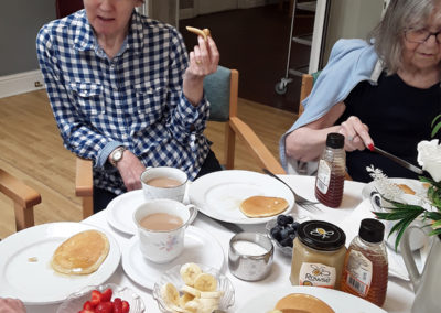 The Old Downs Residential Care Home residents enjoying an afternoon spread of pancakes and fruit