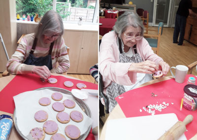 Two Old Downs Residential Care Home residents decorating biscuits