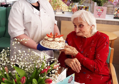 Edna receiving her birthday cake at The Old Downs Residential Care Home