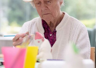 A resident at The Old Downs Residential Care Home enjoying an arts and crafts activity