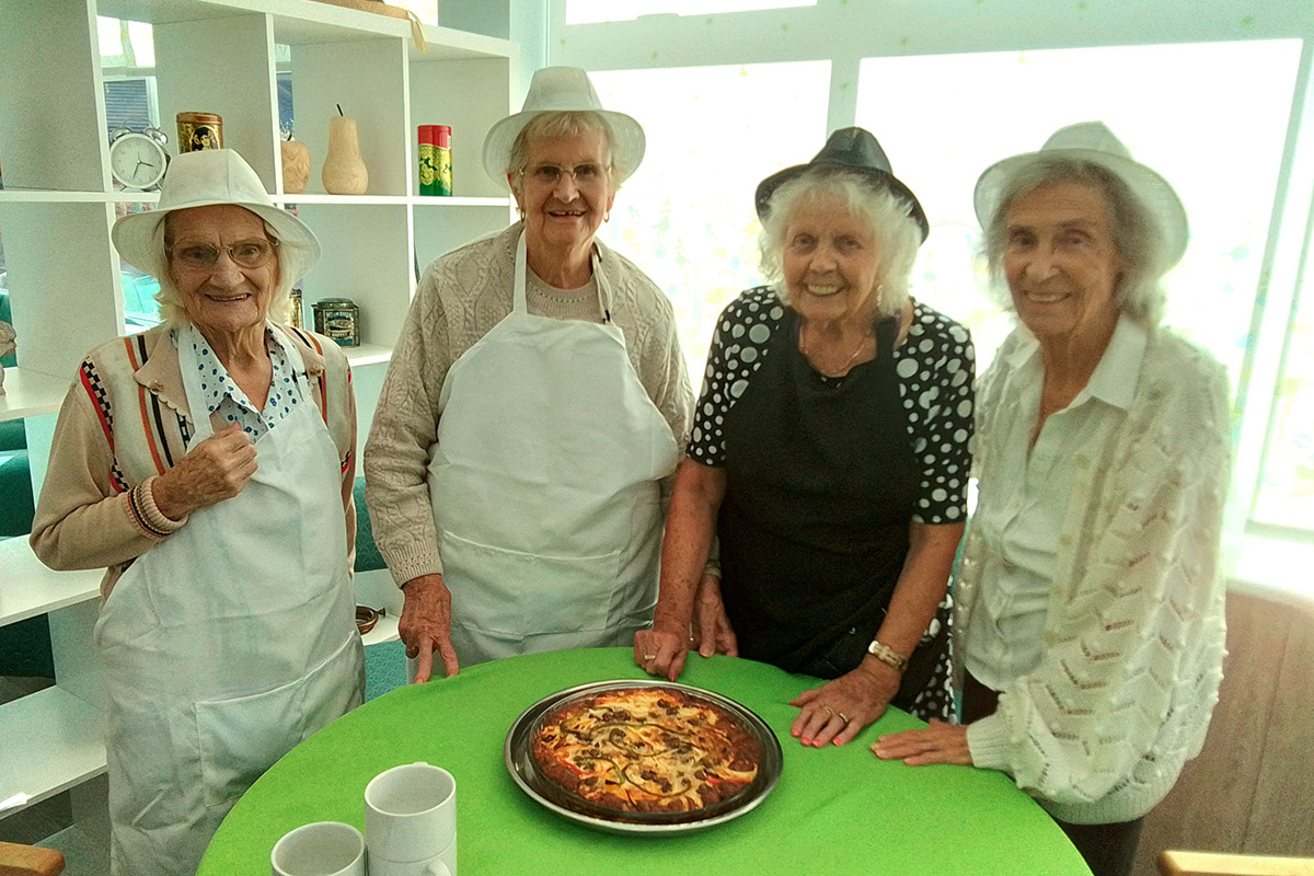 Residents with their quiche at The Old Downs Residential Care Home