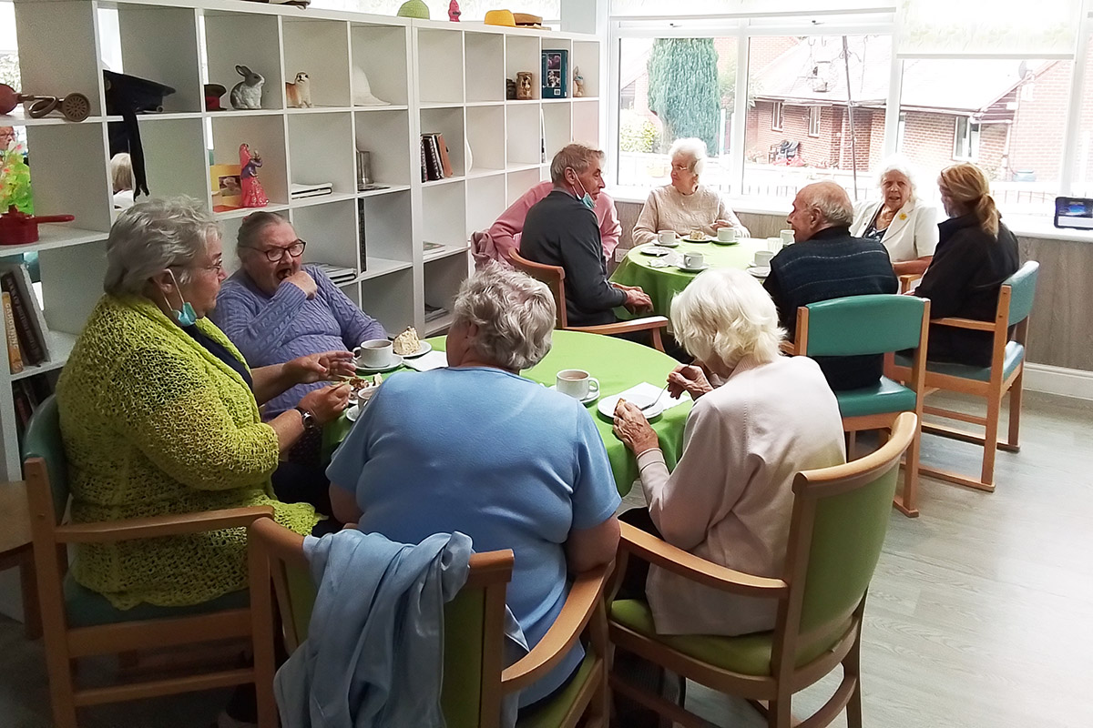 The Old Downs Residential Care Home residents enjoying tea and cake together 