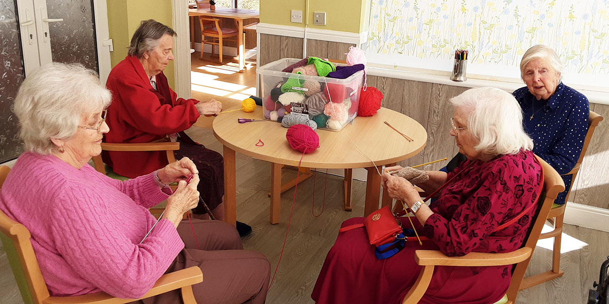The Old Downs Residential Care Home ladies enjoying knitting together