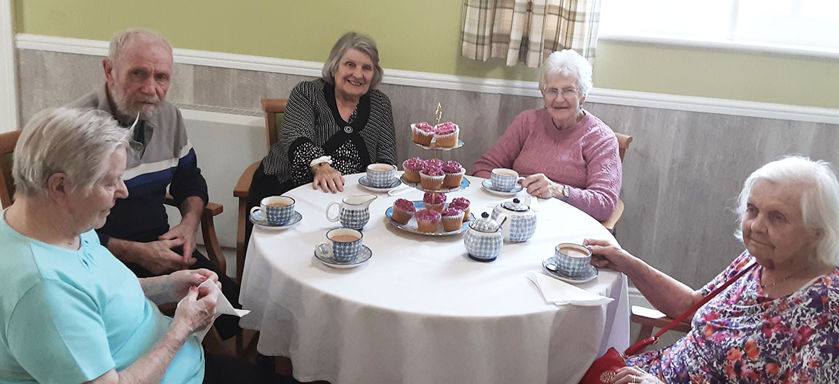 Residents at The Old Downs Residential Care Home enjoying their decorated cupcakes for afternoon tea